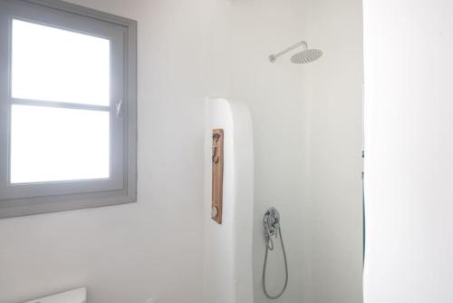 a shower in a bathroom with a window at Swell S9 new studio in Naousa in Naousa