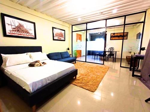 a bedroom with a large bed and a living room at ONYX B&B Bed and Breakfast in Euscara