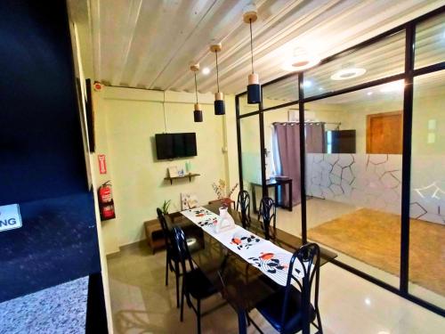 a dining room with a long table and chairs and a room with at ONYX B&B Bed and Breakfast in Euscara