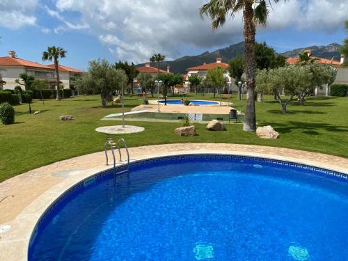 a large blue swimming pool in a park at La casita de mi hermana in Miami Platja