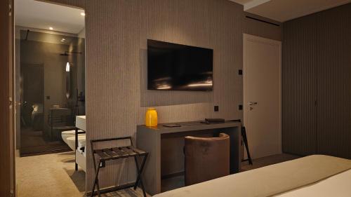 a living room with a television on a wall at Zeta Rentals in Bari