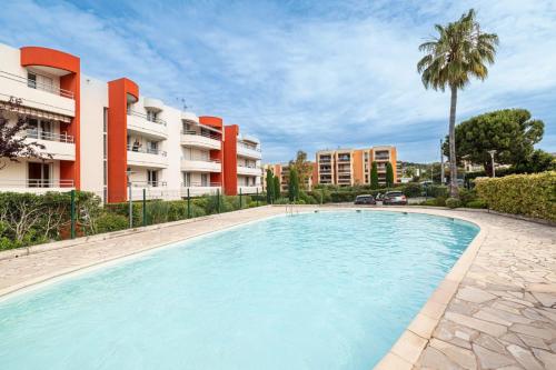 une grande piscine devant un immeuble dans l'établissement Relax Garden, Swimming pool in French Riviera, à Cagnes-sur-Mer