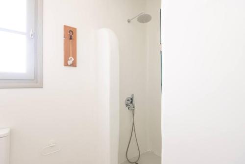 a shower in a white bathroom with a shower at Swell S11 new studio in Naousa in Naousa