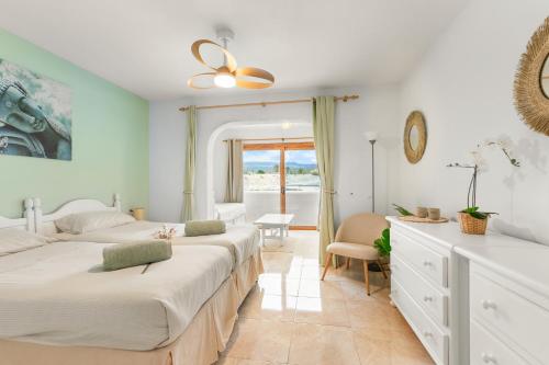 a bedroom with two beds and a window at Beautiful 4 bedroom house with phenomenal golf and mountain views in San Miguel de Abona