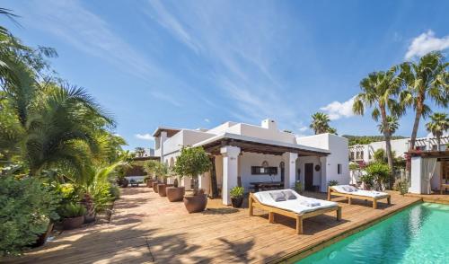 a villa with a swimming pool and a house at VILLA SERENITY 3 Luxury boutique villa in Sant Jordi