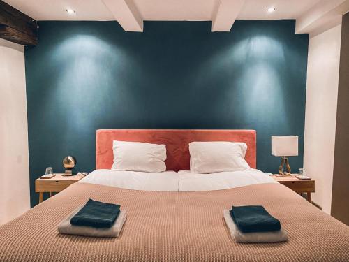 a bedroom with a large bed with two towels on it at Luxurious Loft in Maastricht City Center in Maastricht
