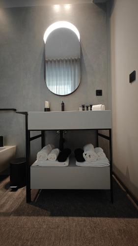 a bathroom with a sink and a mirror and towels at Zeta Rentals in Bari