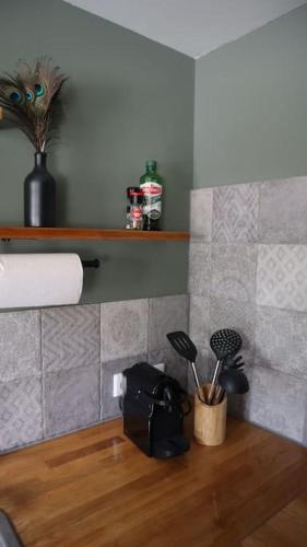a bathroom with a counter with utensils in a holder at Have a nice stay! - Trendy Vakantiehuis Carpe Diem met eigen tuin in Noordwijk