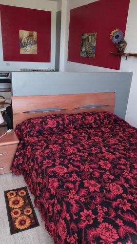 a bedroom with a large bed with red walls at Stay well in Orvieto Scalo