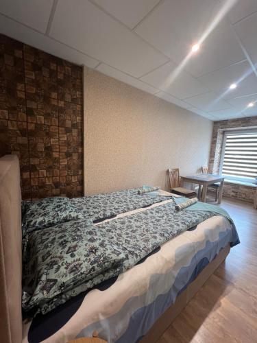 a bedroom with a large bed in a room at Butas Prie Kaštono in Nida