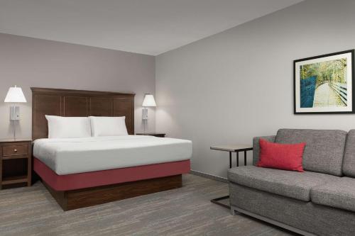 a hotel room with a bed and a couch at Hampton Inn & Suites Orlando North Altamonte Springs in Orlando