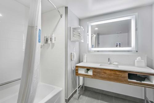 a white bathroom with a sink and a mirror at Hampton Inn Houston-Pearland, TX in Pearland