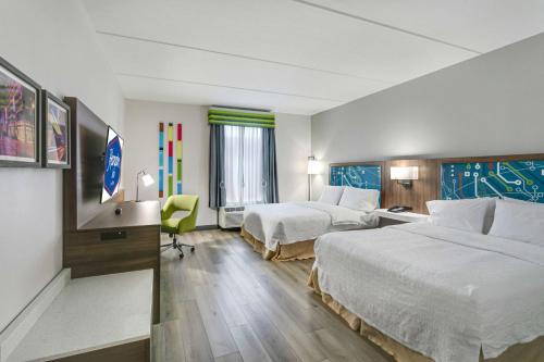 a hotel room with two beds and a desk at Hampton Inn Houston-Pearland, TX in Pearland