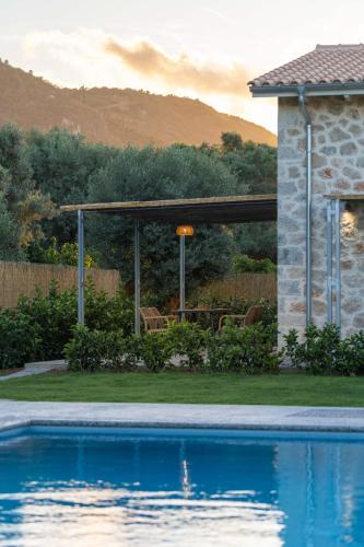 a swimming pool in front of a house at YANNIS RETREAT in Lefkada Town