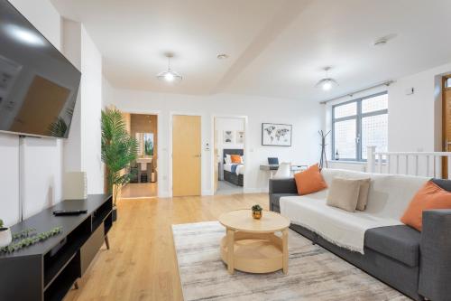 a living room with a couch and a table at 1 Bed Apartment - Redhill Central, Surrey, Gatwick #4 in Redhill