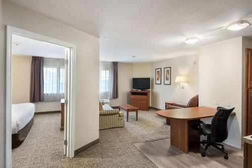 a hotel room with a bed and a desk and a room at Suburban Studios Waterloo in Waterloo