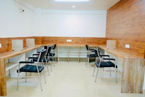 a conference room with a long table and chairs at Elite Enclave - Mysore - 2BHK Luxury Serviced Apartments in Mysore