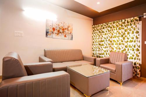 a waiting room with a couch and a table at Elite Enclave - Mysore - 2BHK Luxury Serviced Apartments in Mysore