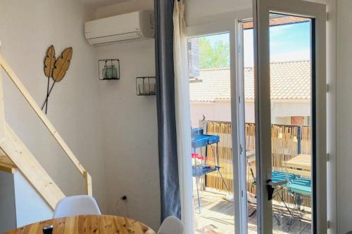 Cette chambre dispose d'une porte coulissante en verre offrant une vue sur la piscine. dans l'établissement Résidence au bord de l étang de Thau, à Marseillan