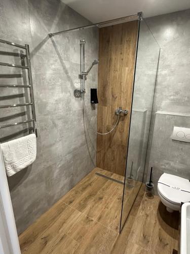 a bathroom with a shower and a toilet at Guest House Zatyshnyi Dvir in Bukovel