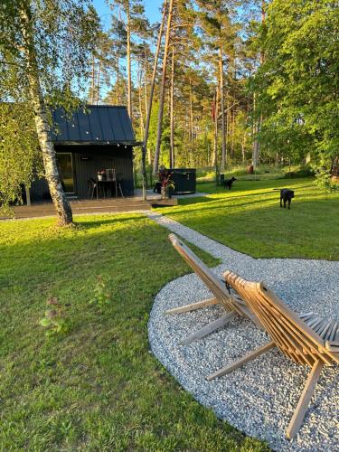 a bench in a park with a building in the background at Baltrozes in Ādaži