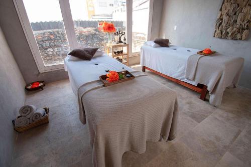 a hotel room with two beds and a window at Hotel Casa Don Luis by Faranda Boutique, a member of Radisson Individuals in Cartagena de Indias