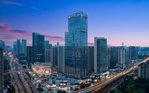 a city skyline with tall skyscrapers and a freeway at Hilton Garden Inn Chengdu Chenghua in Chengdu