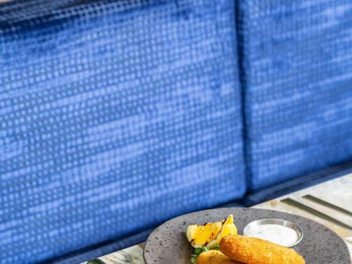a table with a plate of food on a table at Mercure London Earls Court in London
