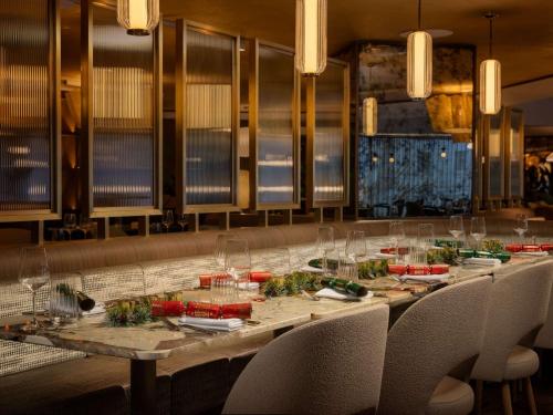 a long table with chairs and plates of food at Mercure London Earls Court in London
