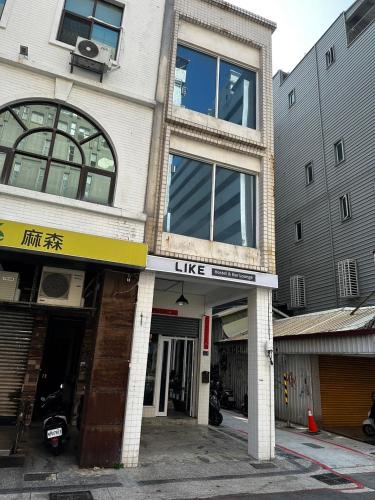 a building with a like sign on the front of it at LIKE Hostel & Bar Lounge in Kaohsiung