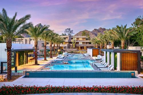an image of a resort pool with palm trees at Arizona Biltmore, LXR Hotels & Resorts in Phoenix