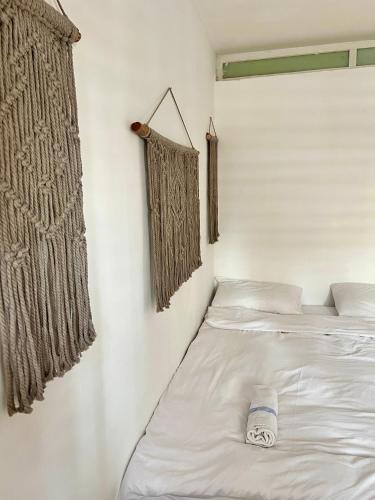 a pair of beds in a room with curtains at Melambai in Eilat