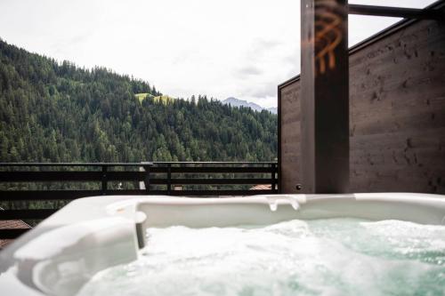 a bath tub with a view of a mountain at Apartments Aois 4 Elements Suites in La Valle