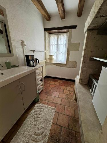 une cuisine avec un évier et une fenêtre dans l'établissement Domaine Beauséjour, à Panzoult