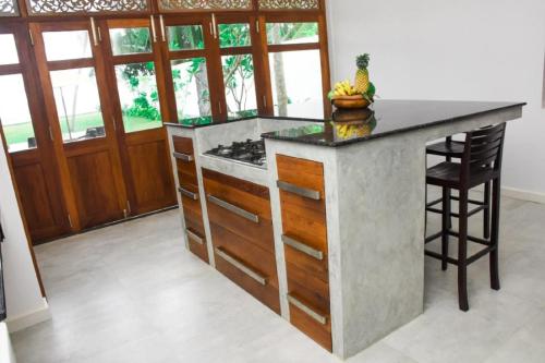 a kitchen with a island with a counter top at Villa Olu in Galle