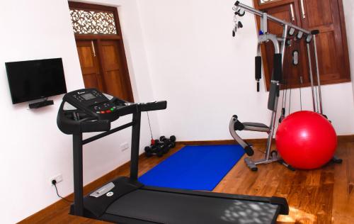 a gym with a treadmill and a red ball at Villa Olu in Galle