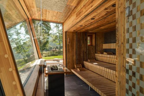 una stanza con pareti in legno e una grande finestra di Hotel Berghof a Ramsau am Dachstein