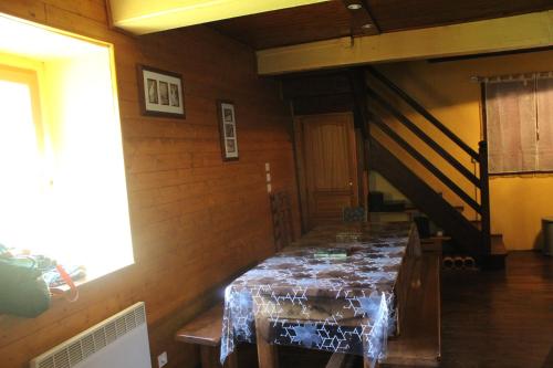 une salle à manger avec une table et un escalier dans l'établissement Maison de charme calme entourée de montagne, à Ussat