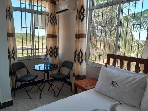 Postel nebo postele na pokoji v ubytování New Luguruni Hotel