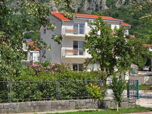 a house with a fence in front of it at Villa BOJANA AS Aparments Risan in Risan
