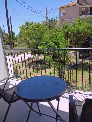 a blue table and chairs on a balcony at SeaEsta vasiliki 2 in Póndi