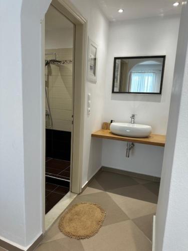 a bathroom with a sink and a mirror at Anna Studios in Agios Prokopios