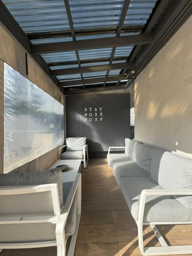 a room with couches and chairs in a train at THE PLACE Muizenberg in Muizenberg