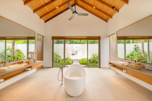 a large bathroom with a large tub and two sinks at RAAYA By Atmosphere - Premium All Inclusive with Free Transfers in Raa Atoll