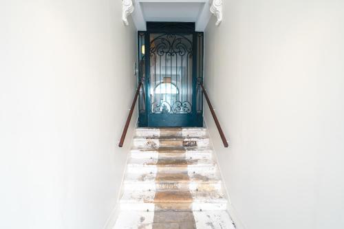 a door in a white building with a stairway at Appartement T3 de Prestige proche du Jardin Public de Bordeaux in Bordeaux