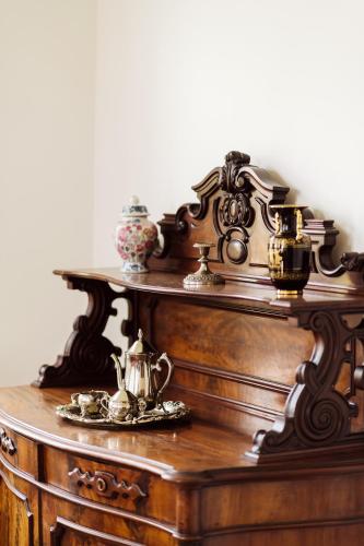 a wooden table with tea sets on top of it at Golf Apartment Villa Elisabeth in Mariánské Lázně