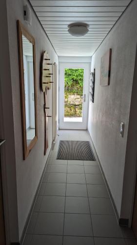 a hallway with a door and a window in a house at Ferienwohnung Hemer in Schrozberg