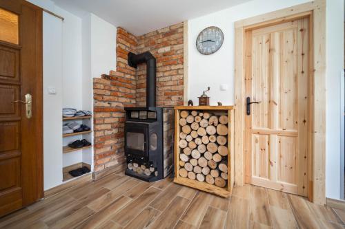 a wood burning stove in a room with a door at Kuća za odmor Dangubica in Kuterevo