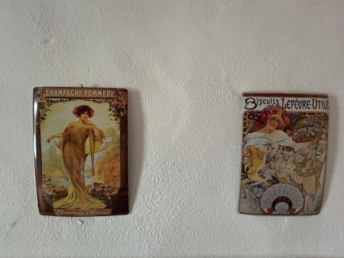 a couple of posters hanging on a wall at Casa Gallinera in Benissiva