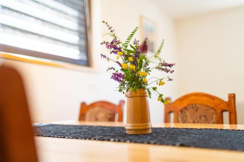 a vase filled with flowers sitting on a table at Kuća za odmor Dangubica in Kuterevo